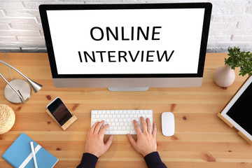 Man using computer for online job interview at table, top view