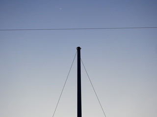 abstract silhouette of pole with blue sky background