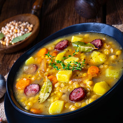 Rustic pea soup with bacon and sausages