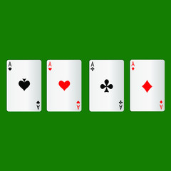 Four aces playing cards on a green background.