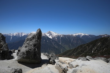 Strange rock with mountains in the background