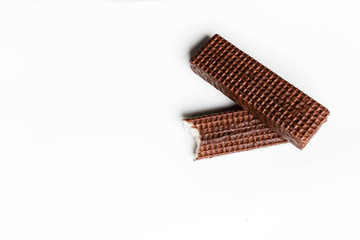 two bitten chocolate wafers on white background
