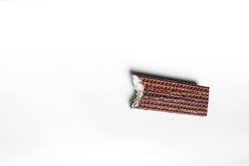 a rectangular piece bitten waffles on a white background