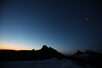 moon over the mountains before dawn