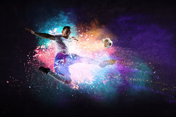 Boy playing soccer hitting the ball