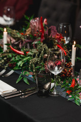 Served restaurant table. Red pepper decoration on a black tablecloth