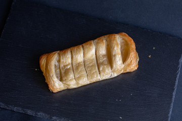 Pastry with apple filling on a marble counter top.