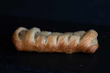 Pastry with apple filling on a marble counter top.