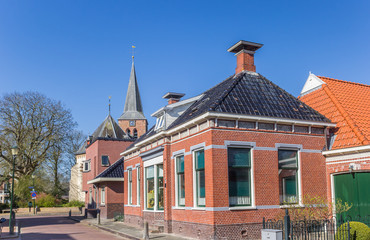 Street with houses and church tower in Warffum, Netherlands