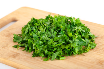 chopped parsley leaf on wooden a board isolated on white background