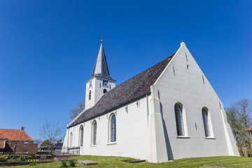 Fototapeta na wymiar Little white church in historic village Vierhuizen, Netherlands