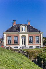 Historic house behind the dike in Zoutkamp, Netherlands