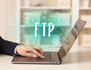 hand working on new modern computer with FTP abbreviation, modern technology concept
