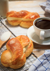 Breakfast, bread and coffee on a wooden table