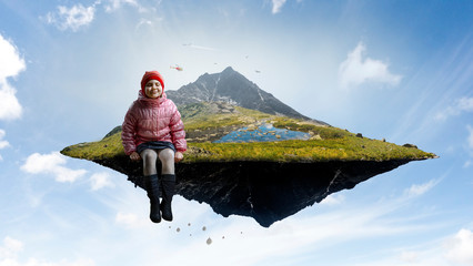Dreamy little girl sitting ready for adventure