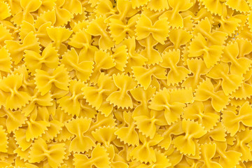 Uncooked farfalle pasta as background, closeup
