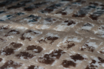 Spotted a fluffy background. The background is plush with white beige and blue spots. Shaggy background.