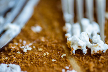 fork knife and spoon covered with apple pie icing on empty baking paper tray