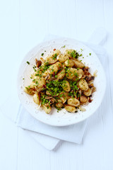 Gnocchi with onion and mushrooms. Bright wooden background. Copy space. Top view. 	