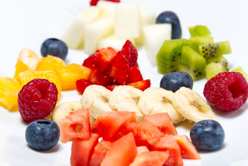 modern Fresh fruit salad on white plate. Mixed fruit in white plate healthy food style. Useful...