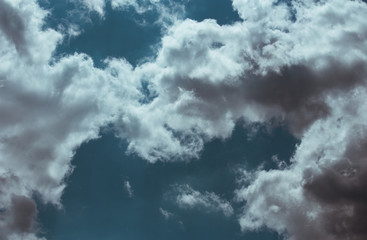 Fototapeta premium Fluffy clouds cover the summer blue sky