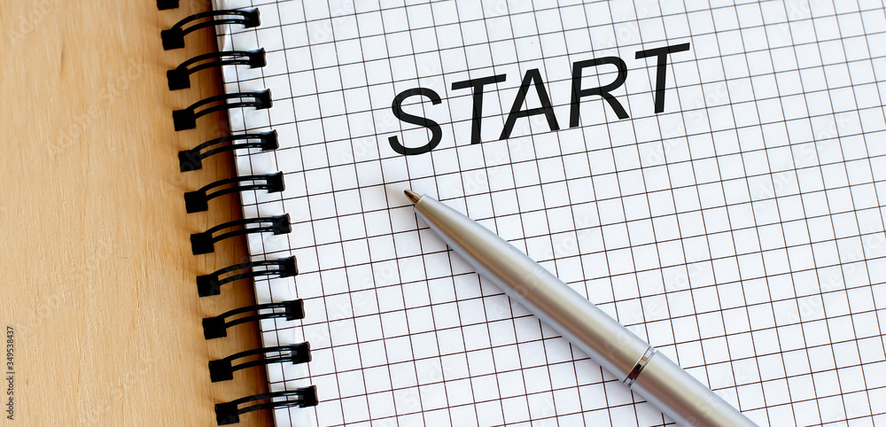 Poster top view of a open notebook with pen and text start