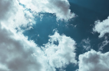 Fototapeta premium Fluffy clouds cover the summer blue sky