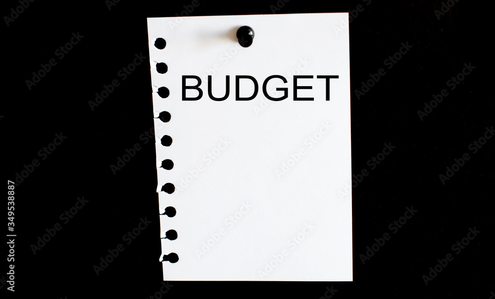 Poster notepad sheet with text busdget on the black background