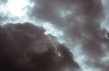 Fluffy clouds cover the summer blue sky