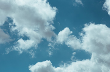 Fototapeta premium Fluffy clouds cover the summer blue sky