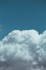 Obraz premium Fluffy clouds cover the summer blue sky