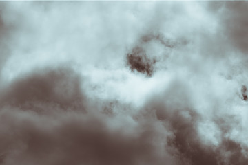 Fluffy clouds cover the summer blue sky