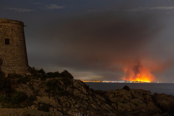 
landscape of a fire seen from the town opposite