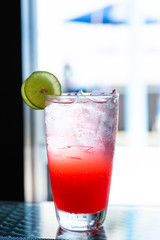 Red mocktail with lime and soda.