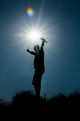 silhouette of a pop artist with a microphone against the background of the sunset