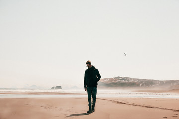 Man on an empty ocean coast.