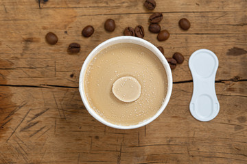 Fototapeta na wymiar Coffee ice cream cup on wood table