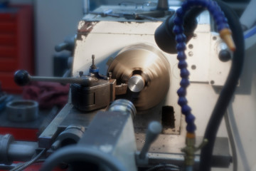 Industrial practice of students on a lathe machine in a factory.