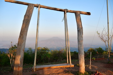 Wooden swings - ropes and chains. Wooden swings are used for tourists to sit and relax while watching the sunrise at Phu Pa Por or Fuji Thailand, which is located in Phu Luang District, Loei Province.