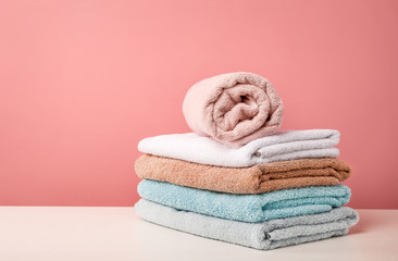 Obraz na płótnie Canvas Stack of bath towels on pink background