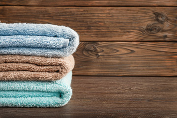 Obraz na płótnie Canvas Stack of bath towels on wooden background