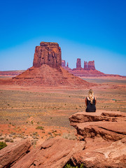 Young blonde girl admires panorama from Artist's Point in Oljato Monument Valley, region of...