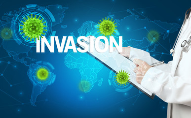 Doctor fills out medical record with INVASION inscription, virology concept