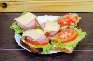 fresh sandwiches with vegetables, meat and cheese