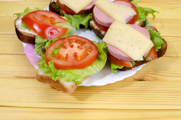 fresh sandwiches with vegetables, meat and cheese close-up