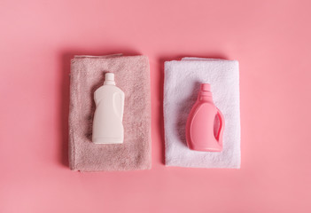 Bath towels and detergents on pink background