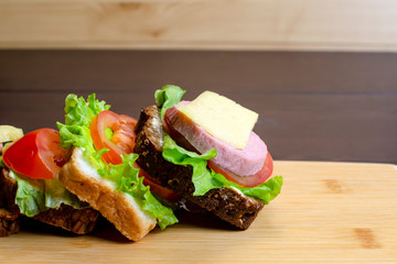 homemade sandwiches on a light cutting board