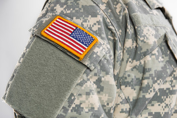 Male in US Army soldier (ISAF) uniform (Patch on the chest with the USA flag). Shot in studio. Isolated on white background