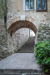Fototapeta na wymiar Arch and stairs in the old city of Arqua Petrarca, Padova, Italy