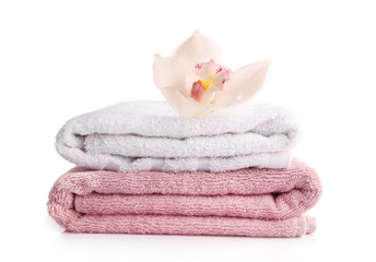 Bath towels with orvhid flower isolated on white
